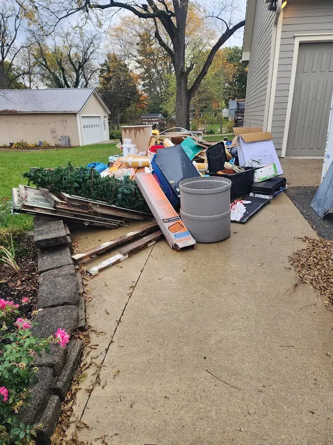 Dumpster being loaded with debris for Residential Dumpster Rental in Holden